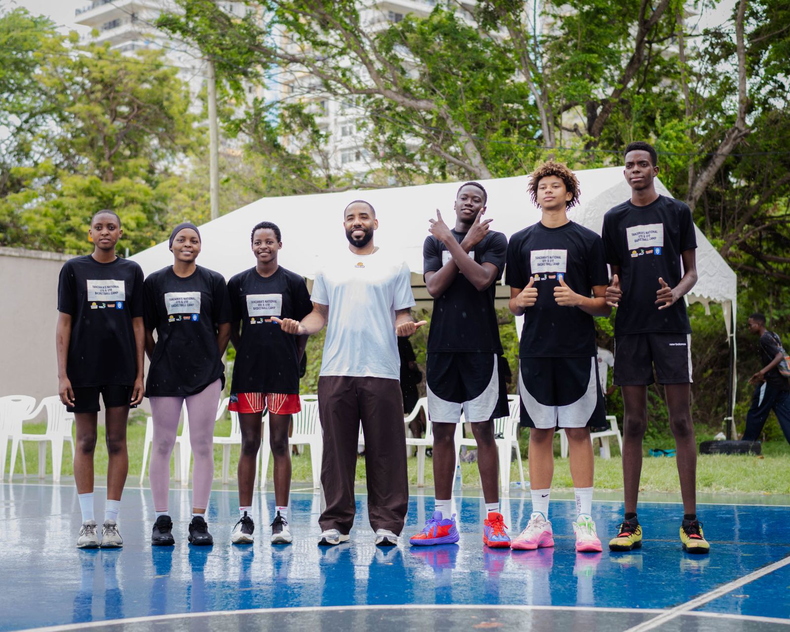 Athletes and a coach lined up on court after a session