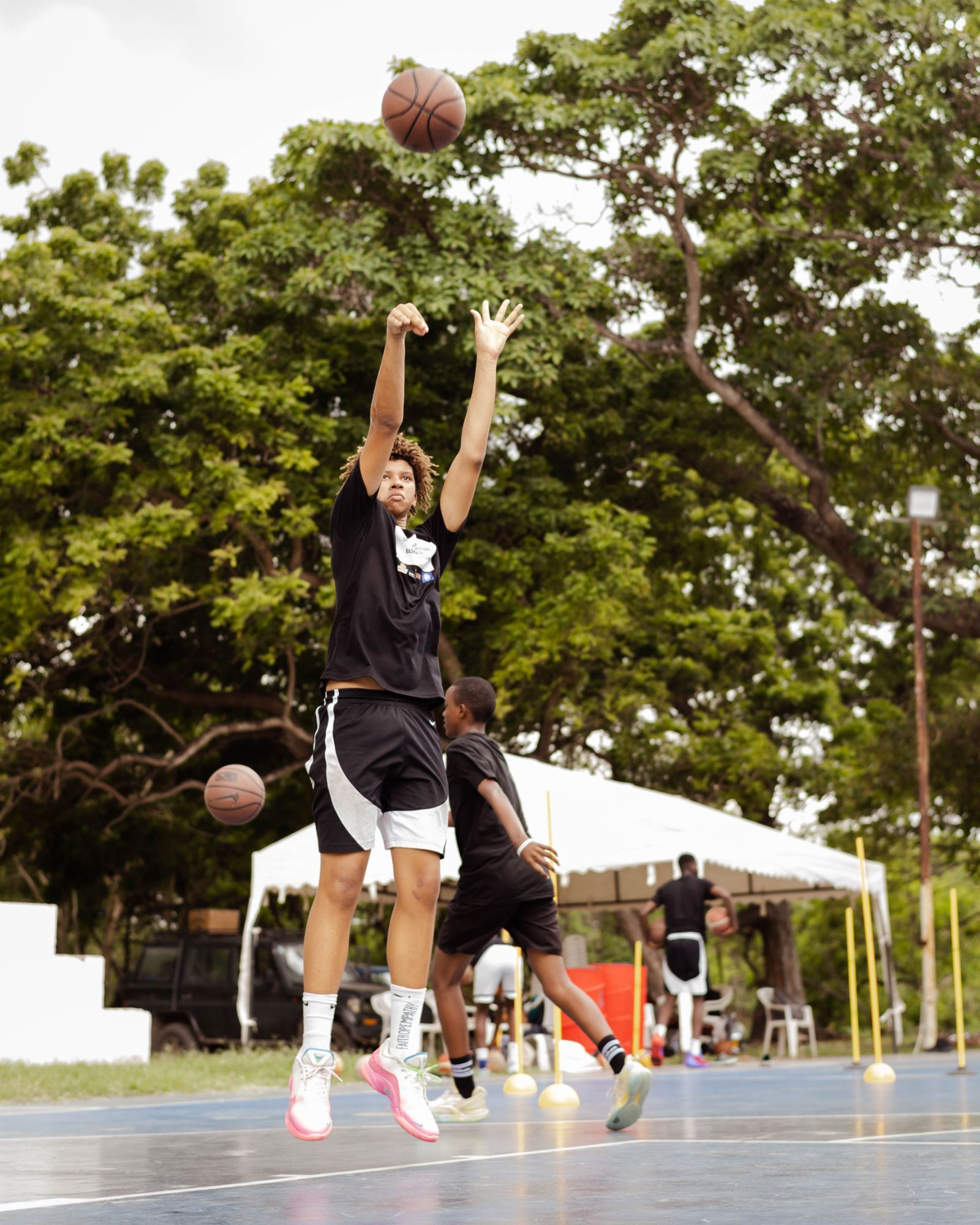An athlete going up for a shot on an outdoor court