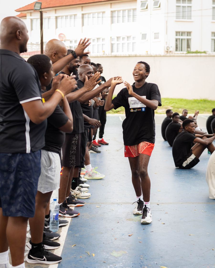 An athlete celebrating with coaches after a drill
