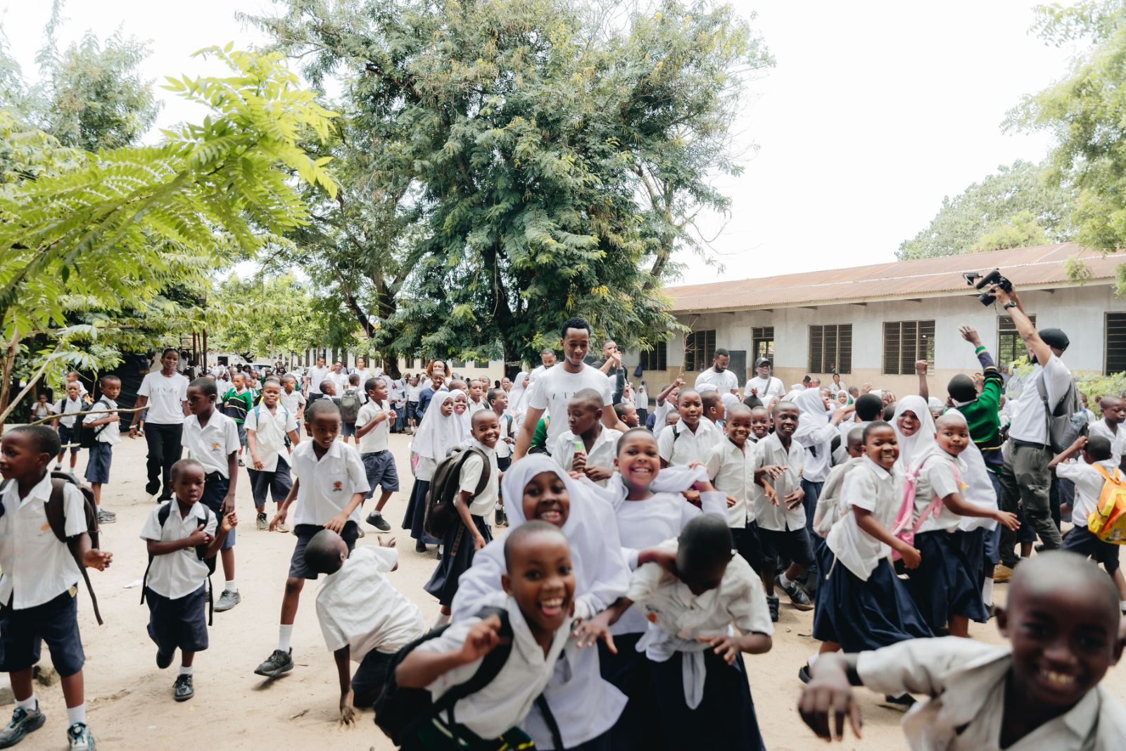 Students in a schoolyard during the school shoe distribution