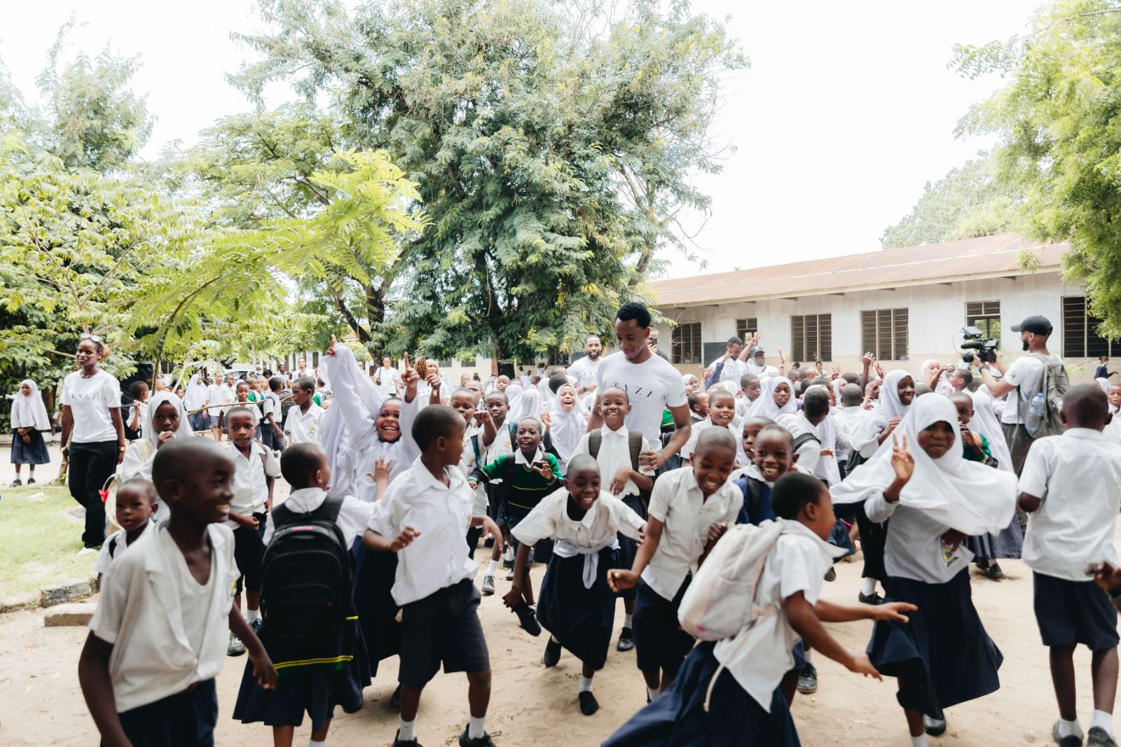 Students gathered in a schoolyard during the school shoe distribution