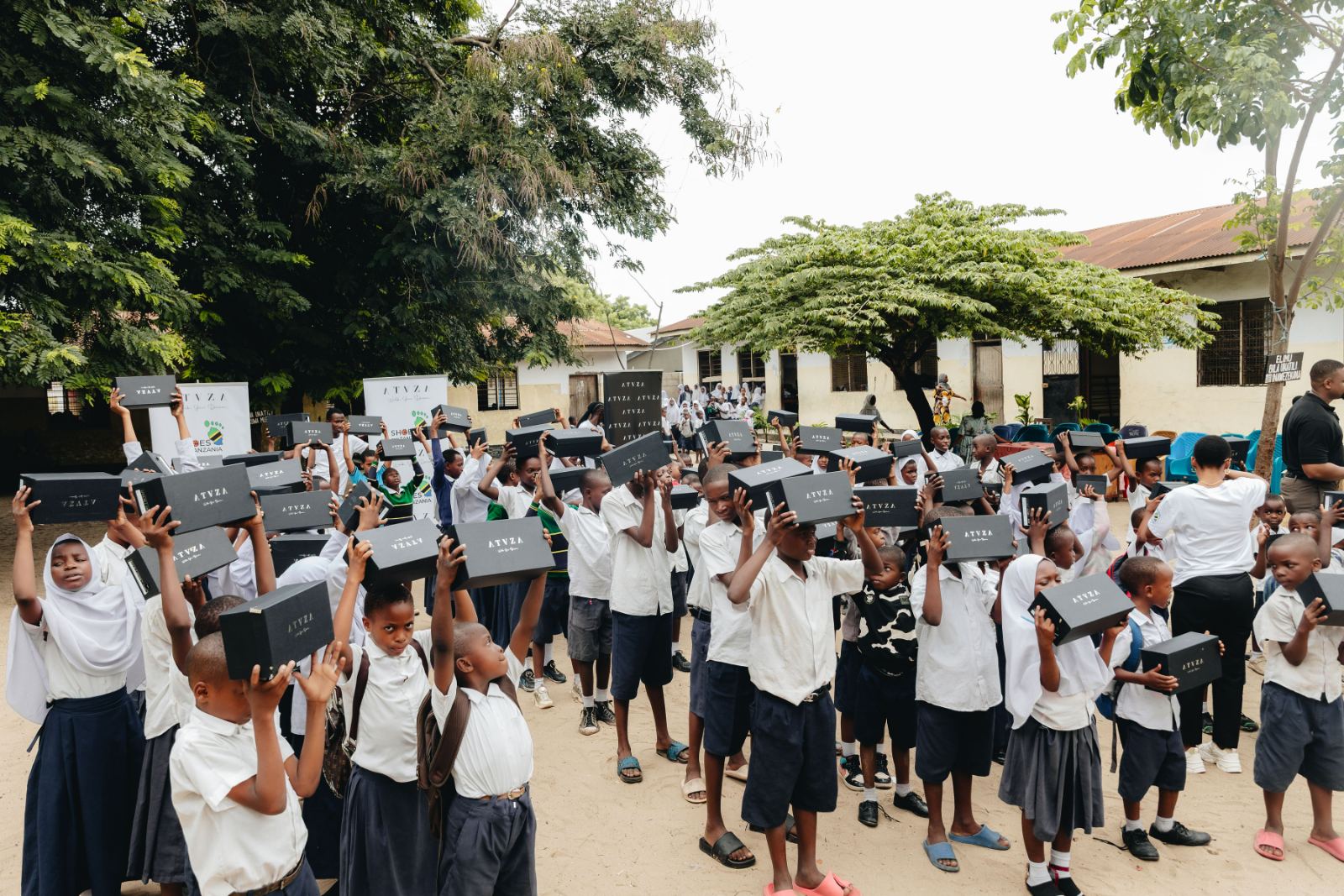 Founder greeting students in a schoolyard